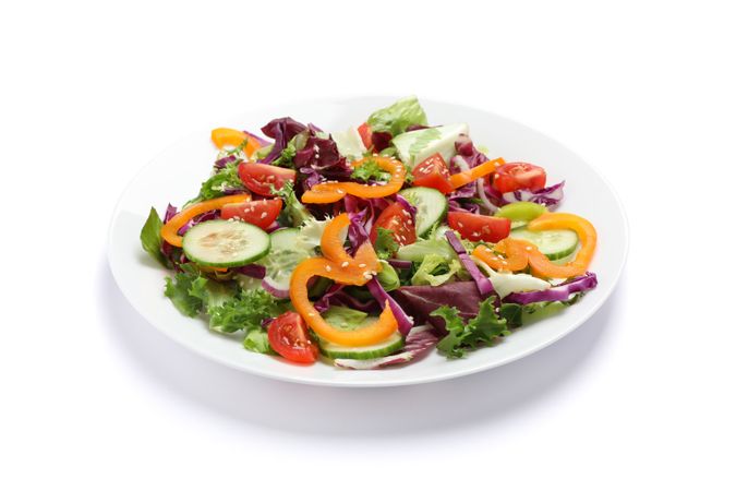 Plate with fresh salad isolated on blank background