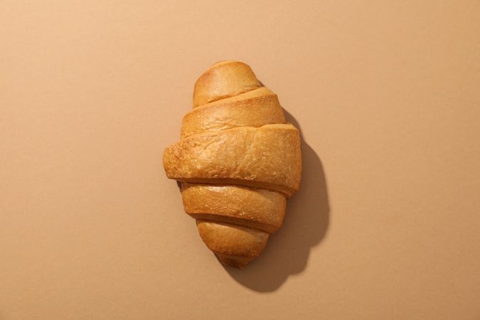 Freshly baked pastry on nude background, top view
