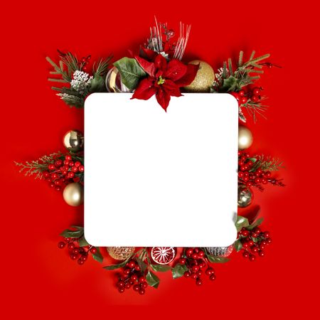 Christmas decoration flat lay with a blank mockup card on a red background.