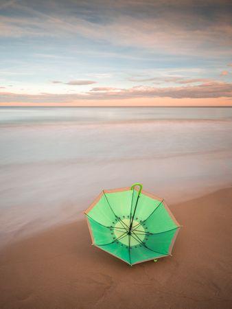 Umbrella on beach near sea