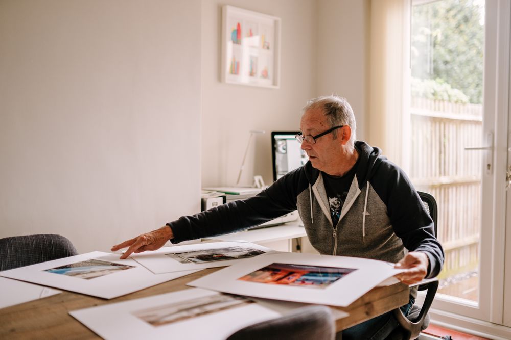 Man looking at photos in his home office
