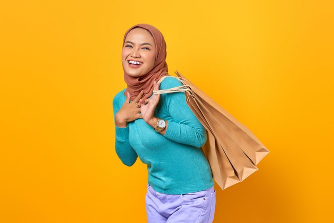 Muslim woman enjoying shopping with bags