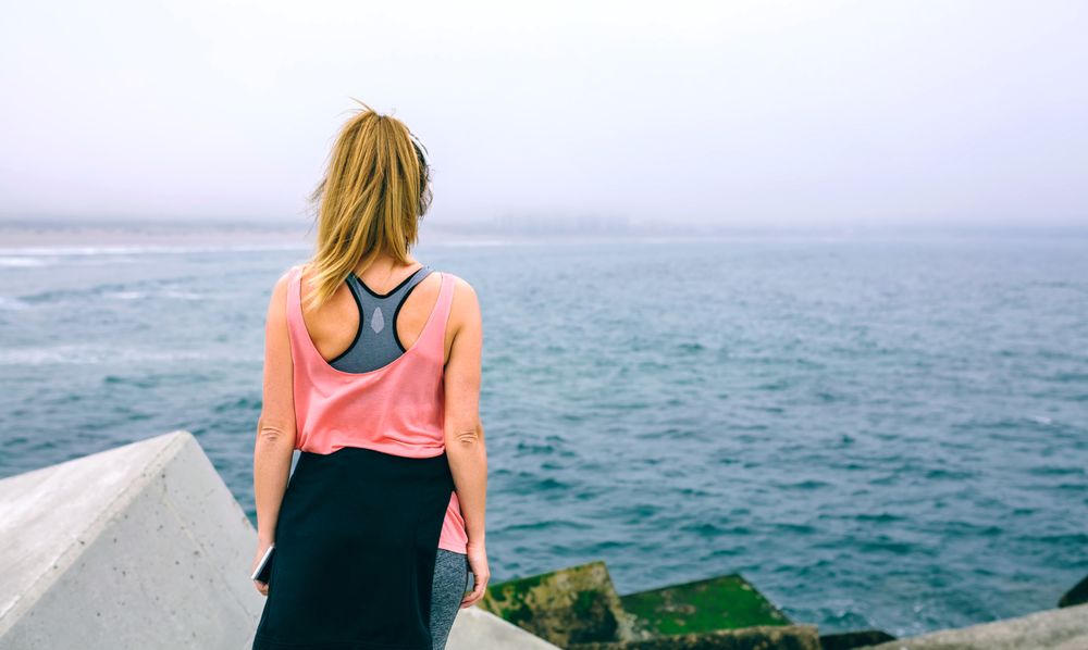 Unrecognizable young woman watching the sea