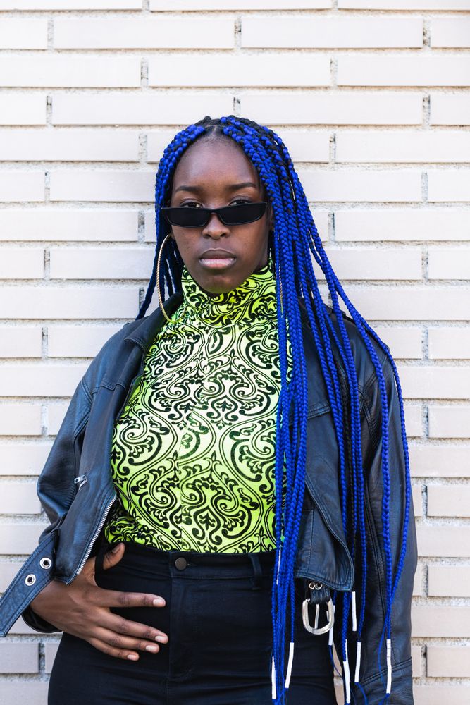 Determined Black woman in trendy clothes in city