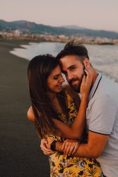 Loving couple embracing happily on sandy beach