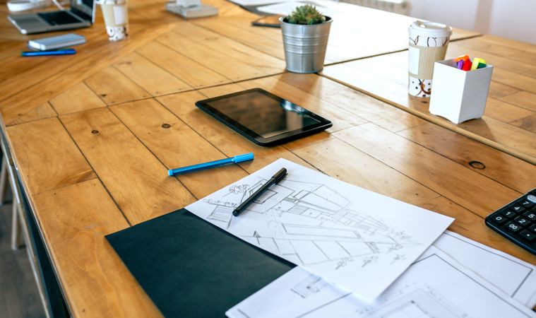 Workplace of an architect with blueprints and sketches
