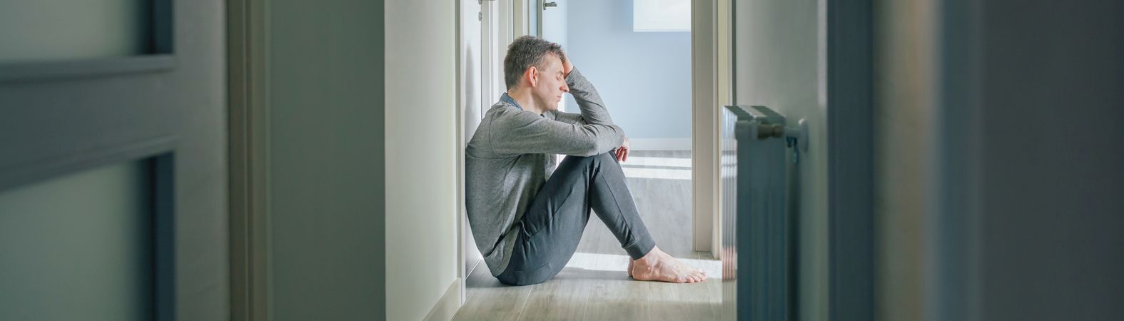 Man with mental disorder and suicidal thoughts sitting on the floor