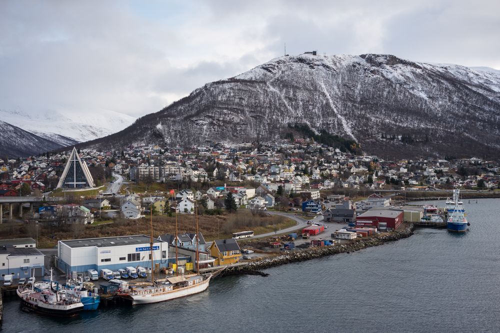 Wonderful cityscape against snowy highland in cold overcast weather