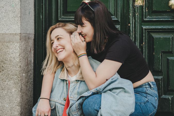 Lesbian couple sitting near door