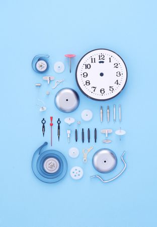 Neatly disassembled clock on blue background