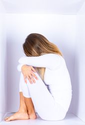 Woman wearing white posing in box