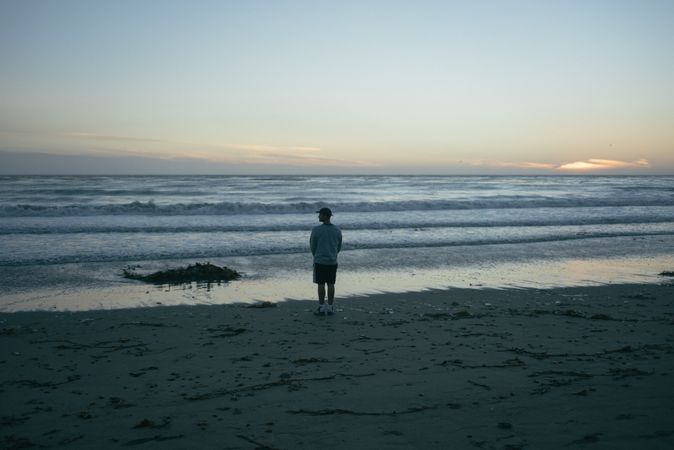 Back of man looking to the side on beach in California