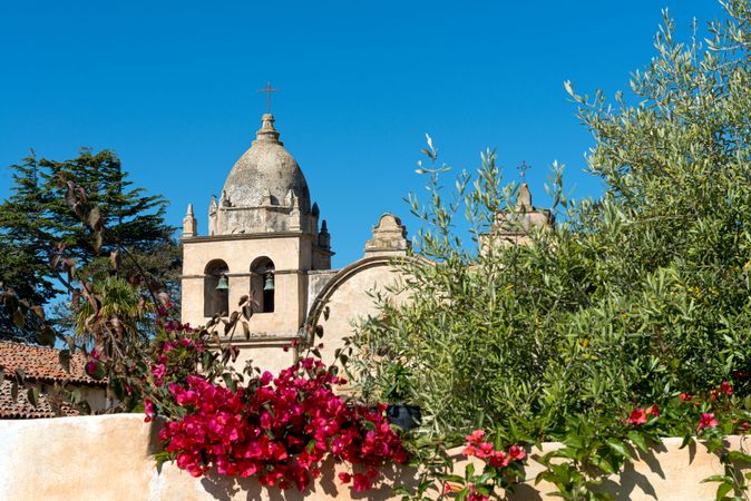 Historic Carmel Mission bell tower with bougainvilleas