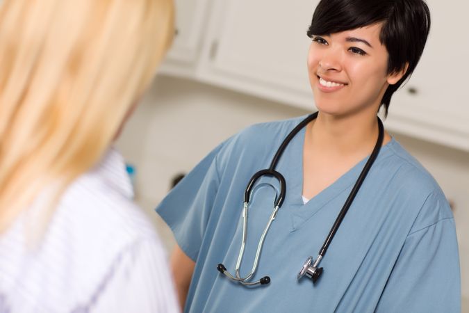 Young Female Doctor Talking with Patient