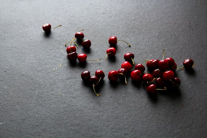 Shiny ripe red cherries on dark background