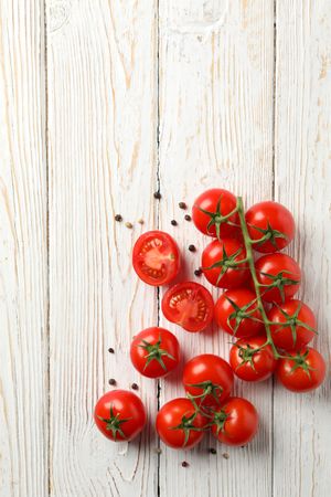 Tomatoes and pepper on wooden background, top view
