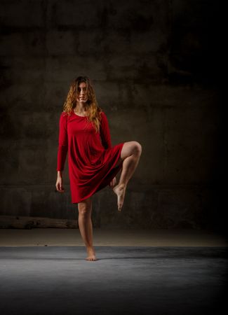 Young woman dancing in darkness