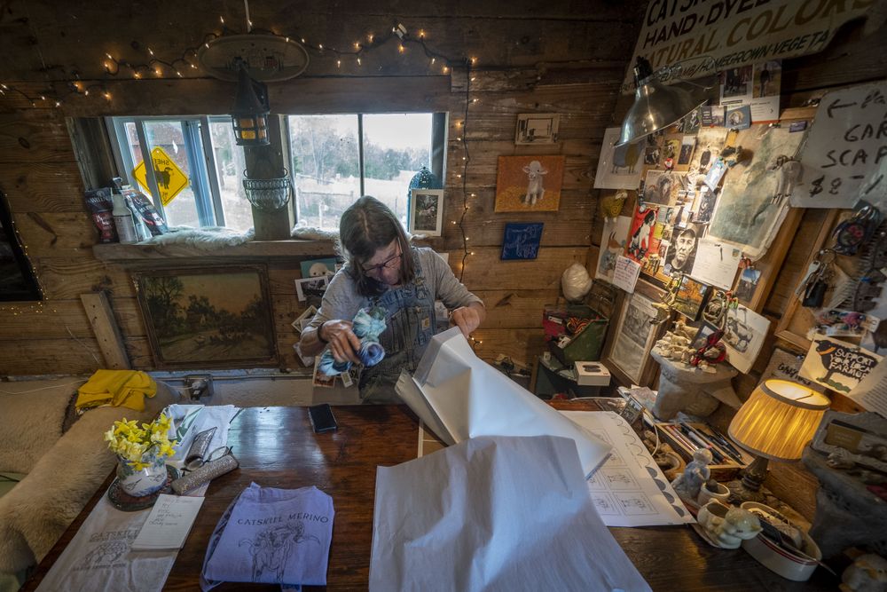 Woman shepherd prepares her merchandise to be sold at a farmers market