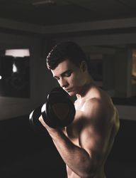 young fitness man doing weights