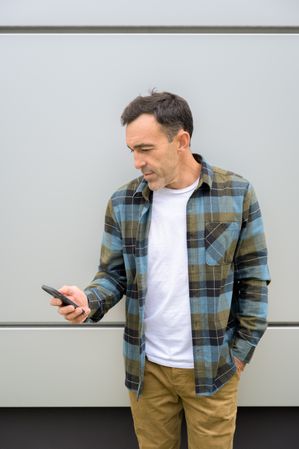 Smiling man using smartphone