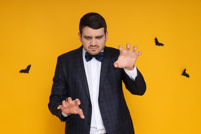 A man in a zombie costume on a yellow background