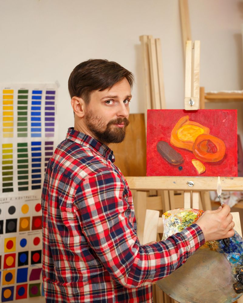 Male painter working on image of pastries