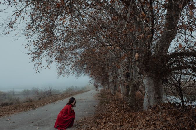 Woman in red dress in foggy area