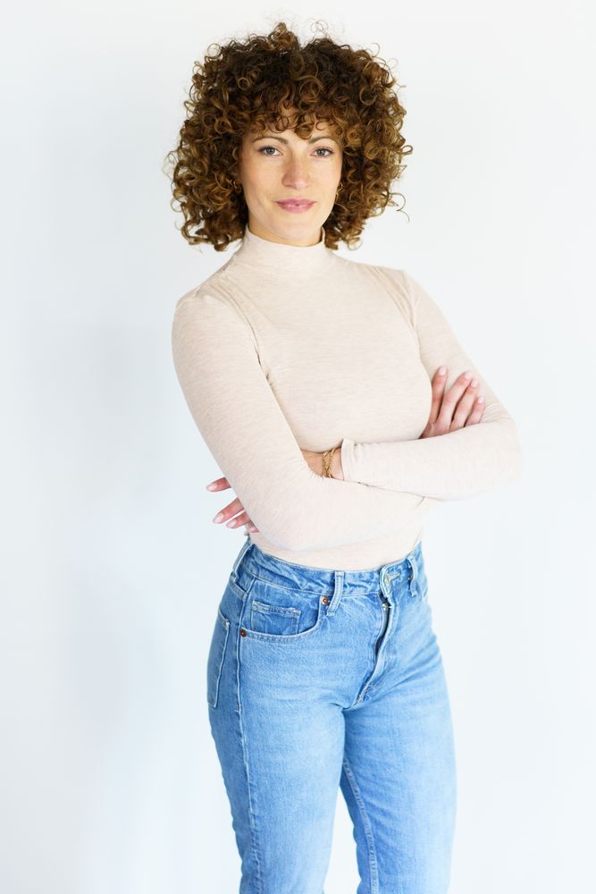 Confident woman in casual clothes with arms crossed, vertical