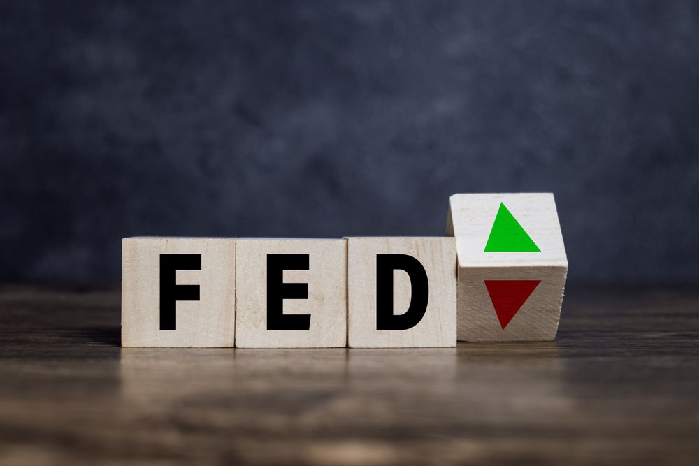 the fed or federal reserve with up and down arrow on wooden blocks
