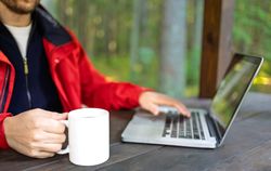Man working remotely in forest gazebo