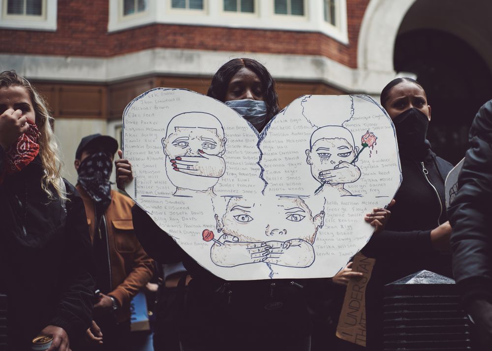 London, England, United Kingdom - June 6th, 2020: Woman in facemark holding heart shaped sign