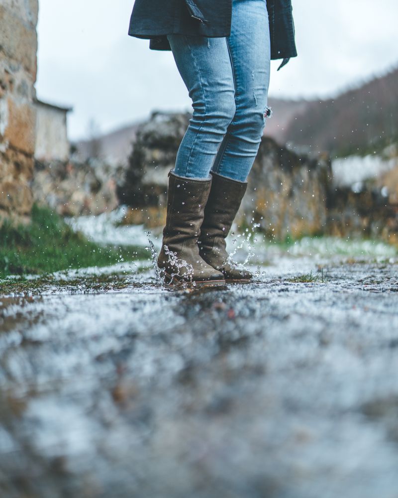 Man walking on wet autumn trail
