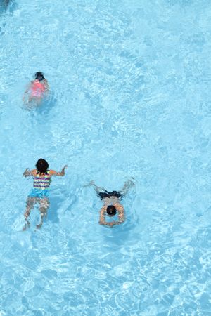 Top view of children swimming in pool