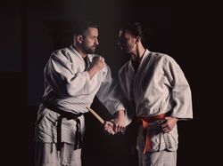 Determined sportsmen practicing self defense technique during judo training