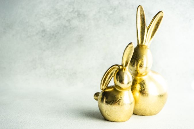 Easter holiday card concept with golden rabbit figurines