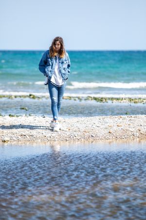 Young woman walking on seashore