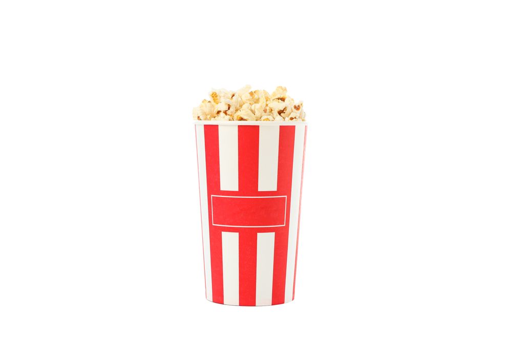 Striped bucket with popcorn isolated on plain background