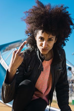 Woman with afro hair making insults.