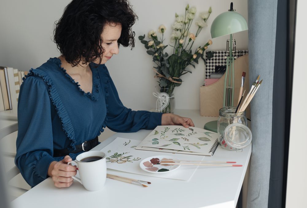 Painter sitting with cup of coffee at work