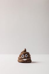 Poop emoticon on light  background