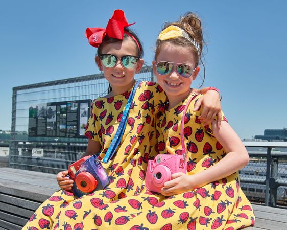 Two girls with sunglasses, and toy cameras visit New York City's High Line, New York City, New York