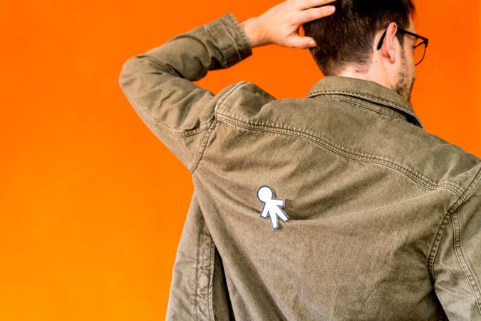 man with funny paper toy on jean jacket