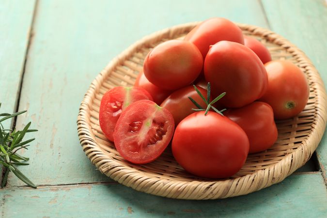 Close Up Fresh Picked Red Tomato Vegetable on Rattan Plate