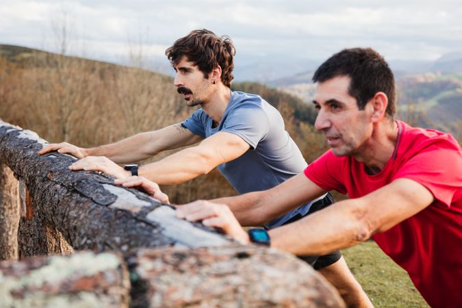 Sportsmen stretching after running in mountains