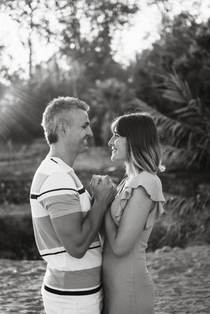 Happy couple looking at each other on beach