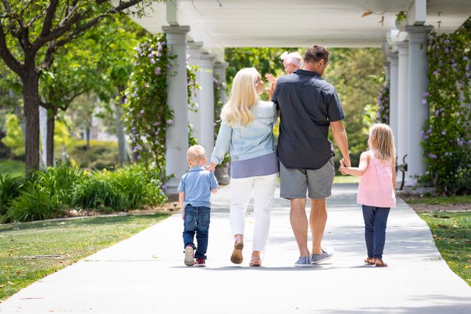 Young Family Taking A Walk In The Park