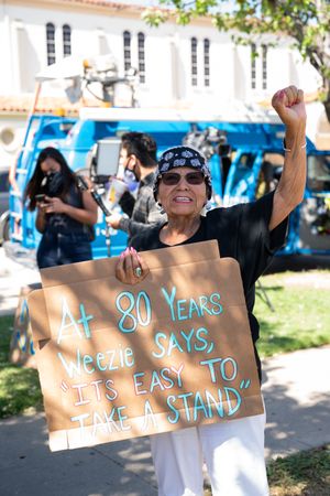 Los Angeles, CA, USA — June 7th, 2020: woman holds up protest sign at BLM event in East Los Angeles