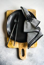 Minimalistic b&w table setting on wooden board