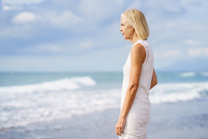 Side view of older female looking out to the ocean