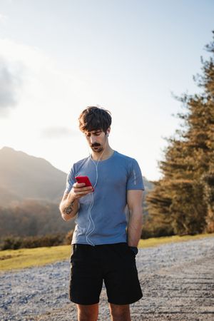 Male runner resting and enjoying mountain landscape